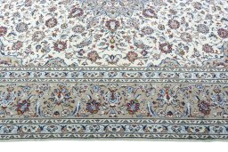 Corner detail of 2000s Kashan rug showing border pattern and Wool pile