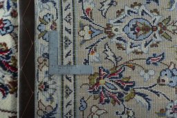 Backside of handmade 2000s Kashan rug showing knot structure and weave density