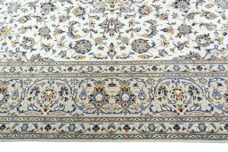 Corner detail of 2000s Kashan rug showing border pattern and Wool pile