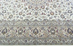Corner detail of 2000s Kashan rug showing border pattern and Wool pile