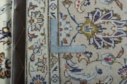 Backside of handmade 2000s Kashan rug showing knot structure and weave density