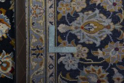Backside of handmade 2000s Kashan rug showing knot structure and weave density