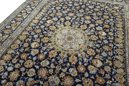 Backside of handmade 2000s Kashan rug showing knot structure and weave density