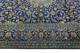 Corner detail of 2000s Kashan rug showing border pattern and Wool pile