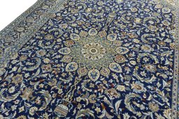 Backside of handmade 2000s Kashan rug showing knot structure and weave density