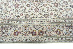 Corner detail of 2000s Kashan rug showing border pattern and Wool pile