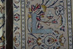 Backside of handmade 2000s Kashan rug showing knot structure and weave density
