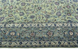Corner detail of 2000s Kashan rug showing border pattern and Wool pile