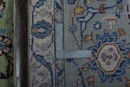 Backside of handmade 2000s Kashan rug showing knot structure and weave density