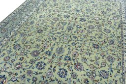 Backside of handmade 2000s Kashan rug showing knot structure and weave density