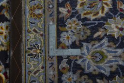 Backside of handmade 2000s Kashan rug showing knot structure and weave density
