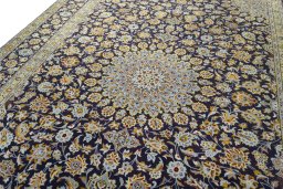 Backside of handmade 2000s Kashan rug showing knot structure and weave density