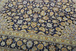 Close-up detail of 2000s Kashan rug from Iran / Persia showing Wool weave