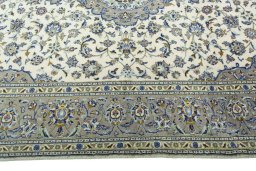 Corner detail of 2000s Kashan rug showing border pattern and Wool pile
