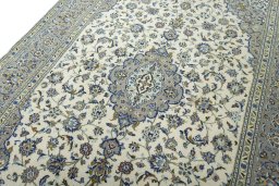 Backside of handmade 2000s Kashan rug showing knot structure and weave density