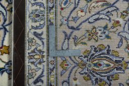 Backside of handmade 2000s Kashan rug showing knot structure and weave density
