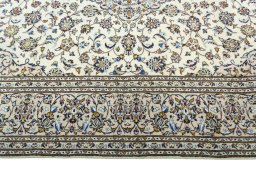 Corner detail of 2000s Kashan rug showing border pattern and Wool pile