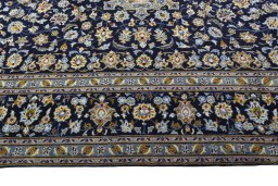 Corner detail of 2000s Kashan rug showing border pattern and Wool pile