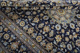Close-up detail of 2000s Kashan rug from Iran / Persia showing Wool weave