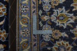 Backside of handmade 2000s Kashan rug showing knot structure and weave density