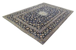 Corner detail of 2000s Kashan rug showing border pattern and Wool pile