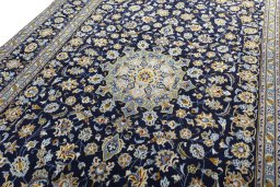 Backside of handmade 2000s Kashan rug showing knot structure and weave density