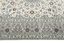 Corner detail of 2000s Kashan rug showing border pattern and Wool pile