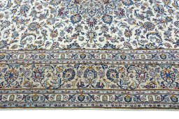 Corner detail of 2000s Kashan rug showing border pattern and Wool pile