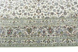 Corner detail of 2000s Kashan rug showing border pattern and Wool pile