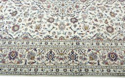 Corner detail of 2000s Kashan rug showing border pattern and Wool pile