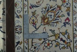 Backside of handmade 2000s Kashan rug showing knot structure and weave density