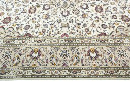 Corner detail of 2000s Kashan rug showing border pattern and Wool pile