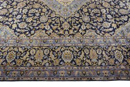 Corner detail of 2000s Kashan rug showing border pattern and Wool pile