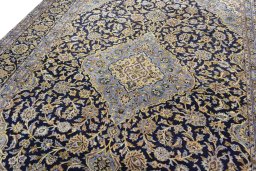 Backside of handmade 2000s Kashan rug showing knot structure and weave density