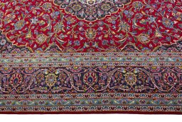 Corner detail of 2000s Kashan rug showing border pattern and Wool pile