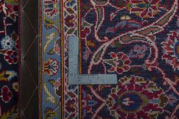 Backside of handmade 2000s Kashan rug showing knot structure and weave density