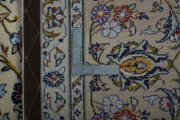 Backside of handmade 2000s Kashan rug showing knot structure and weave density