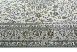 Corner detail of 2000s Kashan rug showing border pattern and Wool pile