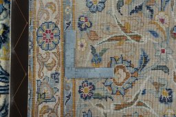 Backside of handmade 2000s Kashan rug showing knot structure and weave density