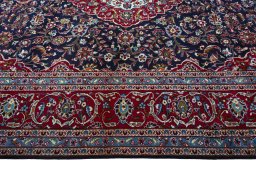 Corner detail of 2000s Kashan rug showing border pattern and Wool pile