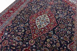Backside of handmade 2000s Kashan rug showing knot structure and weave density