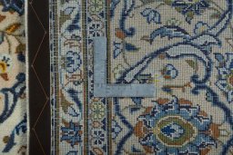 Backside of handmade 2000s Kashan rug showing knot structure and weave density