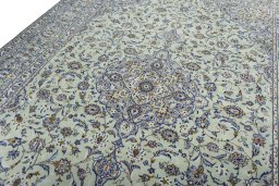 Backside of handmade 2000s Kashan rug showing knot structure and weave density
