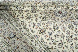 Corner detail of 2000s Kashan rug showing border pattern and Wool pile
