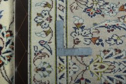 Backside of handmade 2000s Kashan rug showing knot structure and weave density
