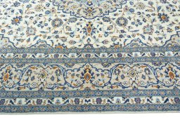 Corner detail of 2000s Kashan rug showing border pattern and Wool pile
