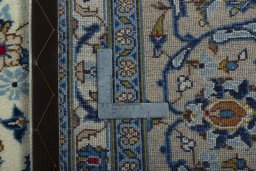 Backside of handmade 2000s Kashan rug showing knot structure and weave density