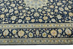 Corner detail of 2000s Kashan rug showing border pattern and Wool pile