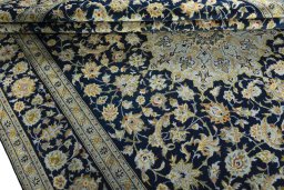 Close-up detail of 2000s Kashan rug from Iran / Persia showing Wool weave
