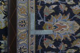 Backside of handmade 2000s Kashan rug showing knot structure and weave density